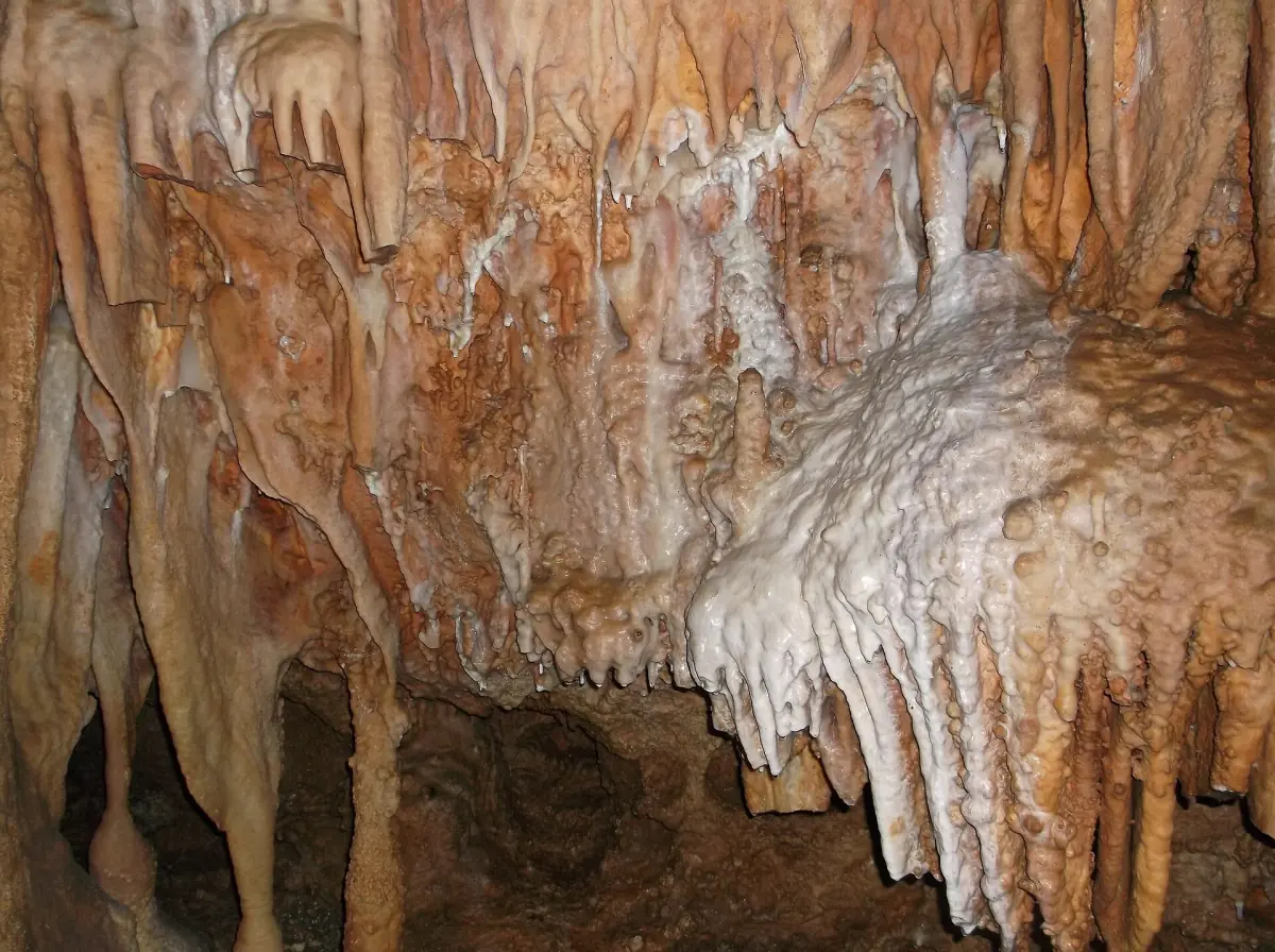 Orange and white stalactites and flowstone draperies inside Bridal Cave near Camdenton