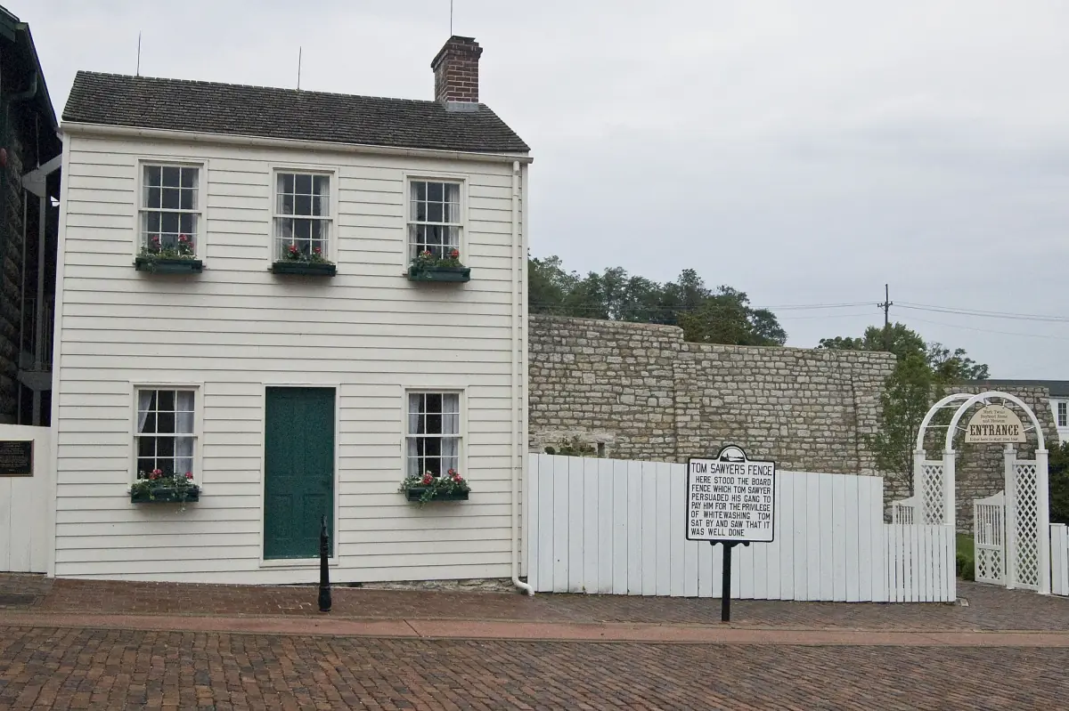 White two-story Mark Twain Boyhood Home with a fence in Hannibal, Missouri