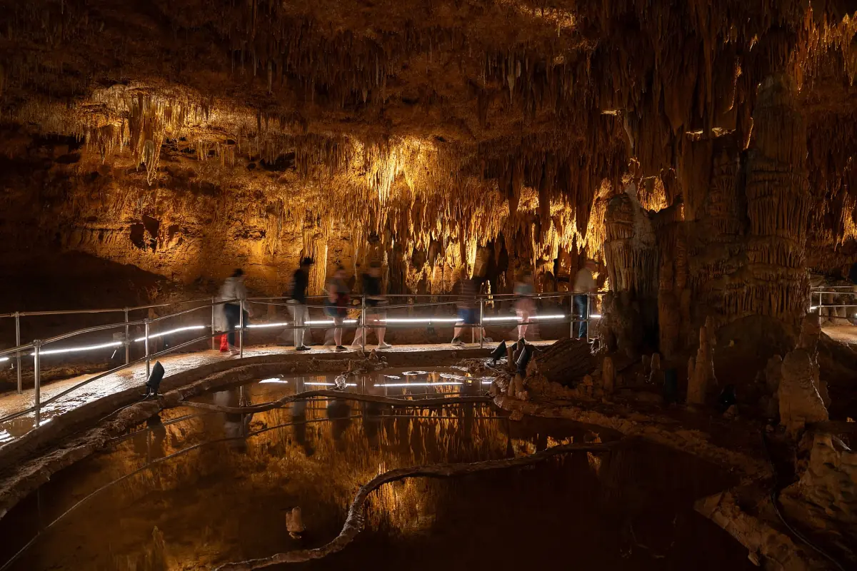 Stalactites and flowstone above the railing of the tour path in Onondaga Cave